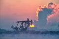 The oil sucking machines lakeside sunrise in winter in Daqing oil fields Royalty Free Stock Photo