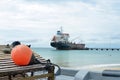 Oil tanker ship at dock with lobster pot trap and buoy Picnic C Royalty Free Stock Photo