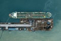 Oil tanker ship in industrial port aerial top view, logistic and transportation oil and gas industry Royalty Free Stock Photo