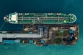 Oil tanker ship in industrial port aerial top view, logistic and transportation oil and gas industry Royalty Free Stock Photo