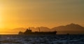 Oil tanker ship in the ocean. Sunset sky. Early in the morning, the sunrise. South Africa. Mossel Bay Royalty Free Stock Photo