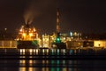 Oil tanker unloading cargo at night