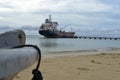 Oil tanker vessel at dock with boat bow in foreground anchor pu Royalty Free Stock Photo