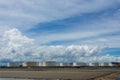 Oil tanks in a row under blue sky, Large white industrial tank for petrol, oil refinery plant. Energy and power