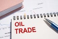 OIL TRADE text written on notepad with pen on financial documents Royalty Free Stock Photo