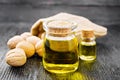 Oil walnut in jar and bottle on board Royalty Free Stock Photo