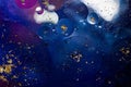 Oil on a water surface with bubbles and pieces of Gold leaf. Abstract colorful background. Close-up, not illustration Royalty Free Stock Photo