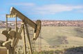 Oil Well Against Mountains and Blue Cloudy Sky Spring Scene