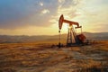 Oil well drilling rig at sunset Royalty Free Stock Photo