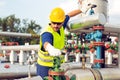 Oil worker closes the valve on the oil pipeline Royalty Free Stock Photo