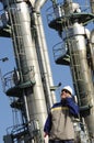 Oil worker in front of oil and fuel towers Royalty Free Stock Photo