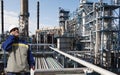 Oil worker inside large chemical refinery Royalty Free Stock Photo