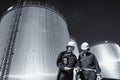 Oil worker with refinery and fuel tanks Royalty Free Stock Photo