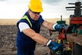 Oil worker is turning valve on the oil pipeline. Oil and Gas Industry. Royalty Free Stock Photo