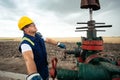 Oil worker is turning valve on the oil pipeline. Oil and Gas Industry. Royalty Free Stock Photo