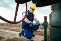 Oil worker is turning valve on the oil pipeline. Oil and Gas Industry. Royalty Free Stock Photo