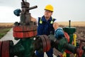 Oil worker is turning valve on the oil pipeline. Oil and Gas Industry. Royalty Free Stock Photo