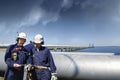 Oil workers with giant main pipeline