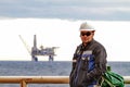 Oilman shift workers on the deck of the ship on the background offshore oil shelf planforms. Work on the way to work Royalty Free Stock Photo