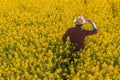 Oilseed rape farmer looking over cultivated field in bloom Royalty Free Stock Photo