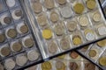 ÃÂ¡oins of different countries are arranged in transparent blisters. Page from album full with old coins. Coin storage method. Royalty Free Stock Photo