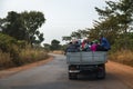 Group of people traveling in the back of a truck in the Oio Region of Guinea Bissau
