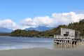 Okarito lagoon and wooden building on stilts, NZ