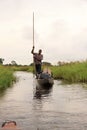 Traditional local man in mokoro boat on river through okavango delta near maun, botswana, africa. Royalty Free Stock Photo