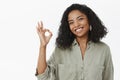 Okay I do it. Portrait of charming friendly and polite happy african american adult woman in blouse tilting head and