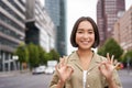 Okay, no problem. Smiling young asian woman shows ok gesture, approve smth, like and agree, accepting, standing on