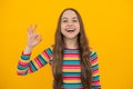 Okay. Portrait of teen girl making ok gesture, isolated background. Young teenager smiling and giving okey sign. Happy Royalty Free Stock Photo