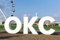 OKC sign and Wheeler Ferris Wheel with skyline. Royalty Free Stock Photo