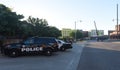 Oklahoma City Police vehicles parked in the early morning shade outside of the Bricktown Police Precinct