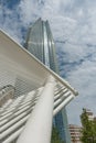 High-rise commercial building towering skyward beyond white steel pipe framework detail