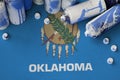 Oklahoma US state flag and few used aerosol spray cans for graffiti painting. Street art culture concept