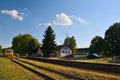 Okna, Ceska Lipa district, Czech republic - July 14, 2018: small train station, trees, parked cars, train and people during sunny