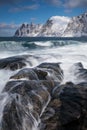 Okneset and Ersfjord from Tungeneset on a stormy day with breaking waves and spray. Sunny day in Mountains And Fjords, Winter