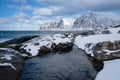 Okneset and Ersfjord from Tungeneset on a stormy day with breaking waves and spray. Sunny day in Mountains And Fjords, Winter