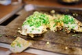 Okonomiyaki in teppanyaki pan at restaurant. Japan food concept