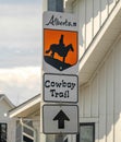 A sign to The Cowboy Trail, a narrow band of mixed forests and grasslands, a wide variety