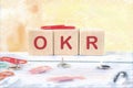 OKR . Objectives and Key Results OKR conceptit is written on wooden cubes on a colored background