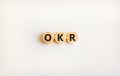 OKR, objectives and key results symbol. Concept words OKR objectives and key results on wooden circles on a beautiful white
