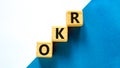 OKR, objectives and key results symbol. Concept words OKR objectives and key results on wooden cubes on a beautiful white Royalty Free Stock Photo