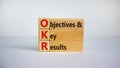 OKR symbol. Concept words `OKR - objectives and key results` on cubes and blocks on a beautiful white background. Business and O Royalty Free Stock Photo