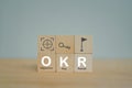 OKR text Objectives, Key and Results on wooden cube blocks on table for  business target and focus concepts Royalty Free Stock Photo
