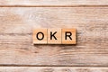 OKR word written on wood block. abbreviation of Objective Key Results text on wooden table for your desing, concept Royalty Free Stock Photo
