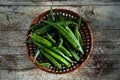 Okra or bhindi, bamia vegetable stacked in a basket on wood background Royalty Free Stock Photo