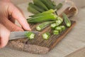 Okra cut with a knife on a chopping board in the kitchen