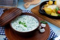 Okroshka - summer cold soup. Cold soup with fresh cucumbers, radishes, potato and sausage. Traditional russian food. Okroshka with Royalty Free Stock Photo
