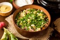 Okroshka. Traditional Russian summer cold soup with sausage, vegetables and kvass in bowl on wooden background. Royalty Free Stock Photo